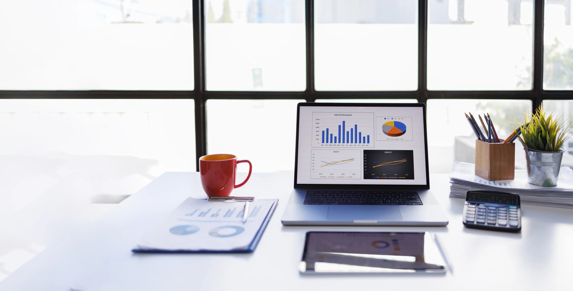 Financial charts and planning documents on a laptop